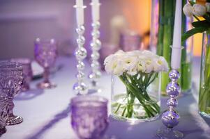 decoration of the evening festive dinner with flowers on the wedding table in the interior of the restaurant. Wedding decor. photo