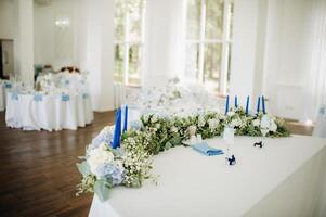 Wedding bride and groom table presidium decorated with a lot of flowers photo