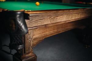 The oak decorative leg of a billiard table looks expensive photo