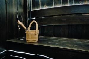 Bucket and ladle in a wooden sauna. Wooden accessories in the sauna photo