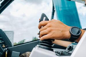 Close-up of a hand holding a joystick to control a crane.Construction concept photo