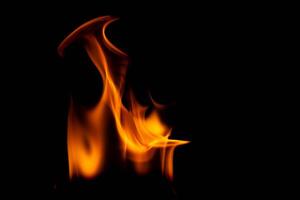 Hot flames on a black background. Beautiful flame of fire in the dark. Abstract of burning flames and smoke. photo