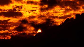 Time lapse of the beautiful sky with clouds at sunset. Sunset sky at dusk in the evening with natural sky background with golden orange clouds. photo