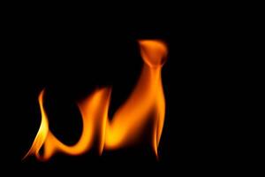 Hot flames on a black background. Beautiful flame of fire in the dark. Abstract of burning flames and smoke. photo