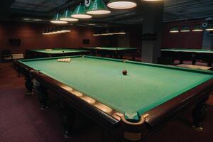 Billiard table with green surface and balls in the billiard club.Pool Game photo