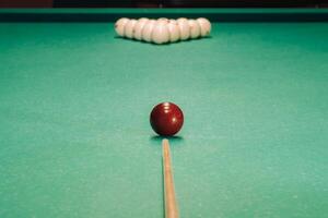 Start of the game of billiards on the green table.The balls are arranged in a triangle on the table photo