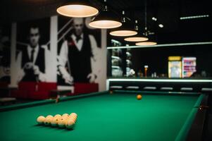 Billiard table with green surface and balls in the billiard club. photo