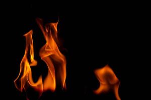 Hot flames on a black background. Beautiful flame of fire in the dark. Abstract of burning flames and smoke. photo