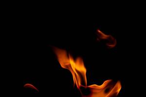 Hot flames on a black background. Beautiful flame of fire in the dark. Abstract of burning flames and smoke. photo