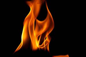 Hot flames on a black background. Beautiful flame of fire in the dark. Abstract of burning flames and smoke. photo