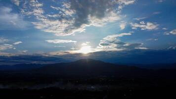 Aerial view of clouds move smoothly in the blue sky. Beautiful nature sunrise over the mountains in the morning. Real amazing sunrise with gentle blue clouds. photo