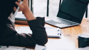 las mujeres asiáticas están estresadas mientras trabajan en una laptop, una mujer de negocios asiática cansada con dolor de cabeza en la oficina, se siente enferma en el trabajo, copia espacio video