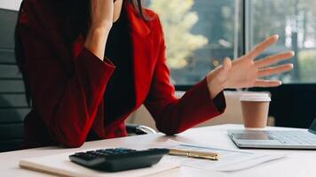 Asian businesswoman in formal suit in office happy and cheerful during using smartphone and working video