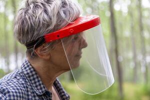 expert female lumberjack with a protective visor photo