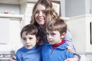 portrait of family relaxing on floor in the kitchen photo