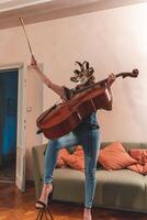 attractive woman wearing a mask is playing a cello photo