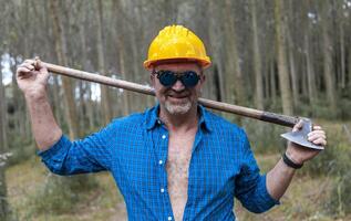 portrait of experienced lumberjack with sunglasses photo