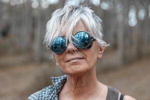 portrait of beautiful mature lumberjack woman with sunglasses photo