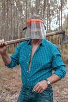 lumberjack in action at work in a forest photo