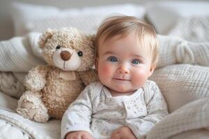 ai generado sonriente bebé con azul ojos siguiente a un marrón osito de peluche oso en un suave cama foto