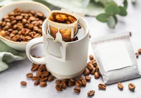 Drip coffee bag with ground coffee in  cup photo