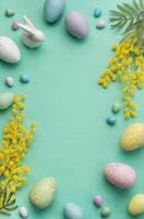 Festive Easter Decoration With Colorful Eggs and Mimosa Flowers on a Pastel Green Background photo