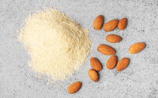 Fresh almond flour  and almonds photo