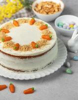 Homemade Easter carrot cake made with walnuts, iced with cream cheese. Sweet dessert. photo