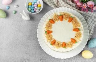 Homemade Easter carrot cake made with walnuts, iced with cream cheese. Sweet dessert. photo