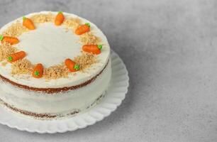 Homemade carrot cake made with walnuts, iced with cream cheese. Sweet dessert. photo