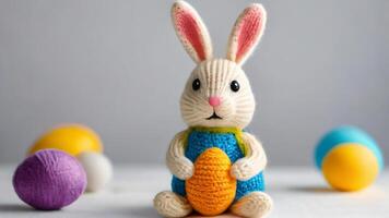 AI generated Photo Of Knitted Easter Bunny With Egg Sitting On A White Background. AI Generated