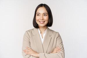 Confident female entrepreneur, asian business woman standing in power pose, professional business person, cross arms on chest, standing over white background photo