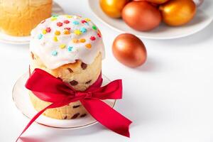 Sweet Easter cake panettone with icing and golden eggs. photo