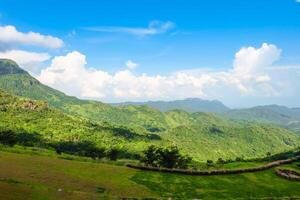 Green hills in mountain valley. blue sky of white clouds Bright day photo