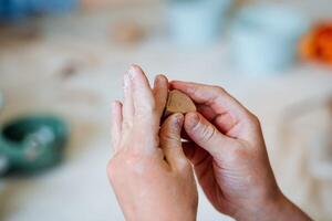 A close shot of children's hands, which are sculpted from clay On the hands of traces of dried clay. photo