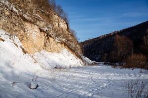 mountainous terrain sun cliffs. earlier morning frost snow. cold season. Spring light is warm. The silence of nature photo