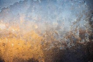 Magical winter patterns on the glass.The texture of the glass covered with frost in winter in cold. Natural phenomena. Frozen water on the window. photo