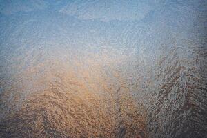 Magical frost and ice patterns on a winter glass. Natural phenomena. Winter decorations, frozen water on the window. photo