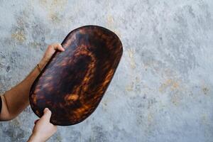 a spotted platter held by a model photo