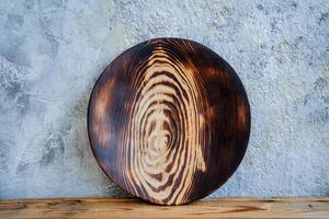 a round wooden item is on the table photo