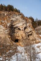 Ust Katavskaya Cave on the Katav River, Southern Ural Russia. Maryin Rock cliff in winter. Hapov ridge in the snow photo