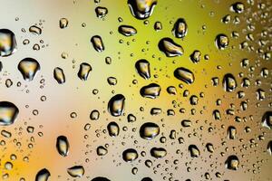 Beautiful multi-colored water droplets on a glass photo