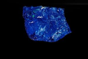 Macro mineral stone Azurite in siltstone against black background photo