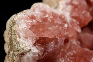 Macro mineral stone Pink Amethyst on a black background photo