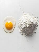 AI generated One egg yolk left and white flour right on white back. High-resolution. AI Generative photo