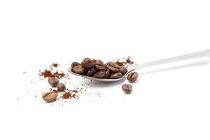 Spoon with coffee beans isolated on white photo