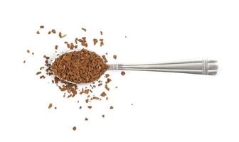 Spoon with instant coffee granules on a white background photo