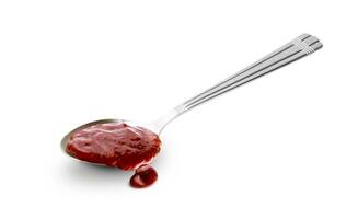 Red barbecue sauce in spoon isolated on white background photo