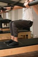 Training session standing on reformer bed photo