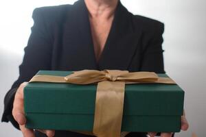 Unrecognizable mature caucasian woman recieving a present photo